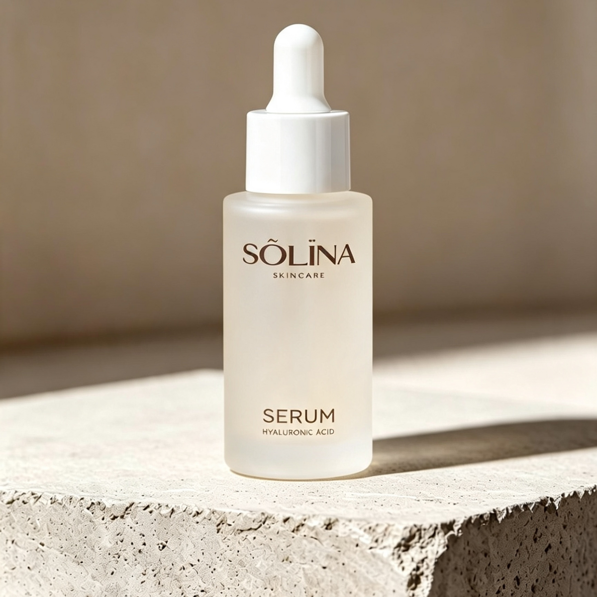Sólina Skincare Serum in a frosted glass dropper bottle with a white cap, displayed on a textured stone pedestal against a warm beige background.